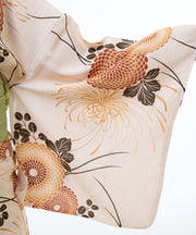 Floral patterned fabric with orange and black flowers on a beige background