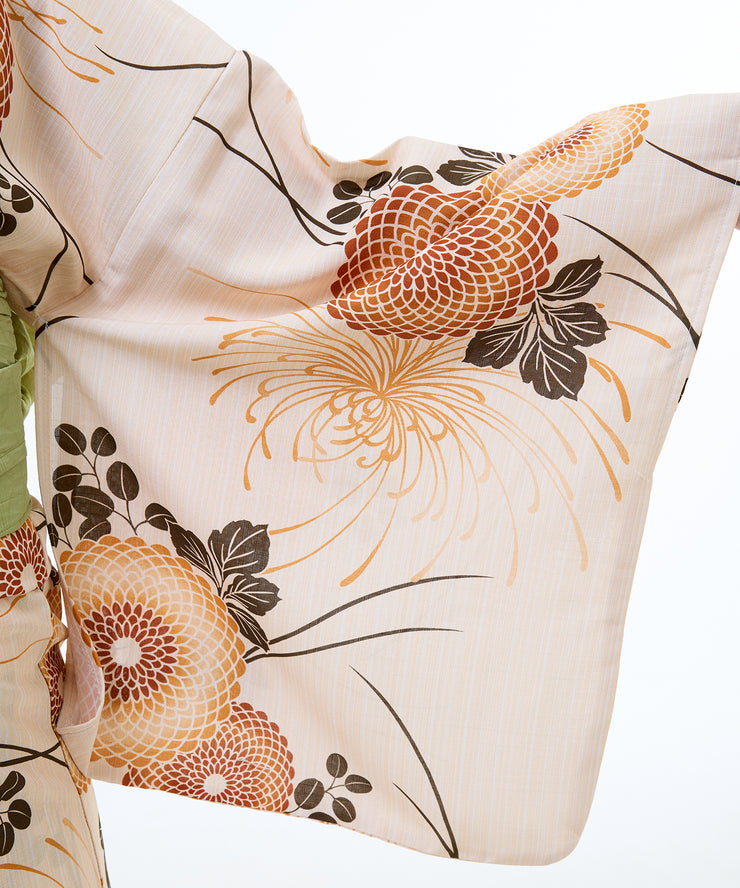 Floral patterned fabric with orange and black flowers on a beige background