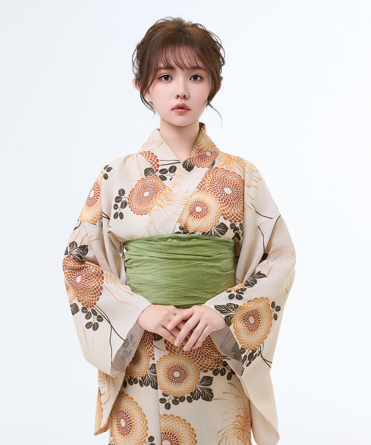 Woman wearing a traditional kimono with floral patterns on a white background