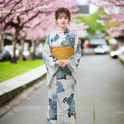Woman wearing a floral kimono with a white background