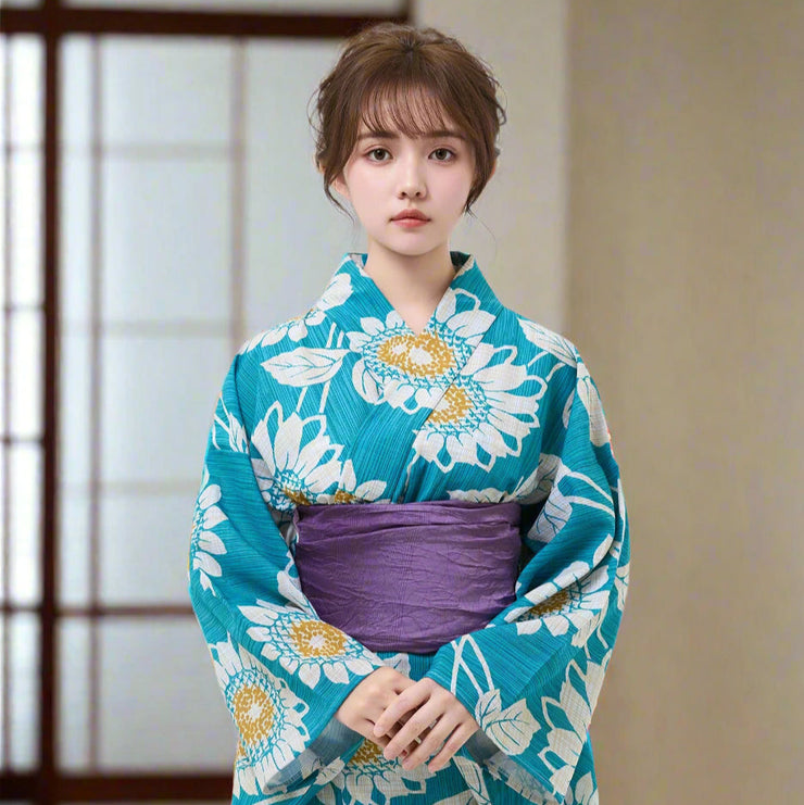 Woman wearing a blue floral kimono with a white background