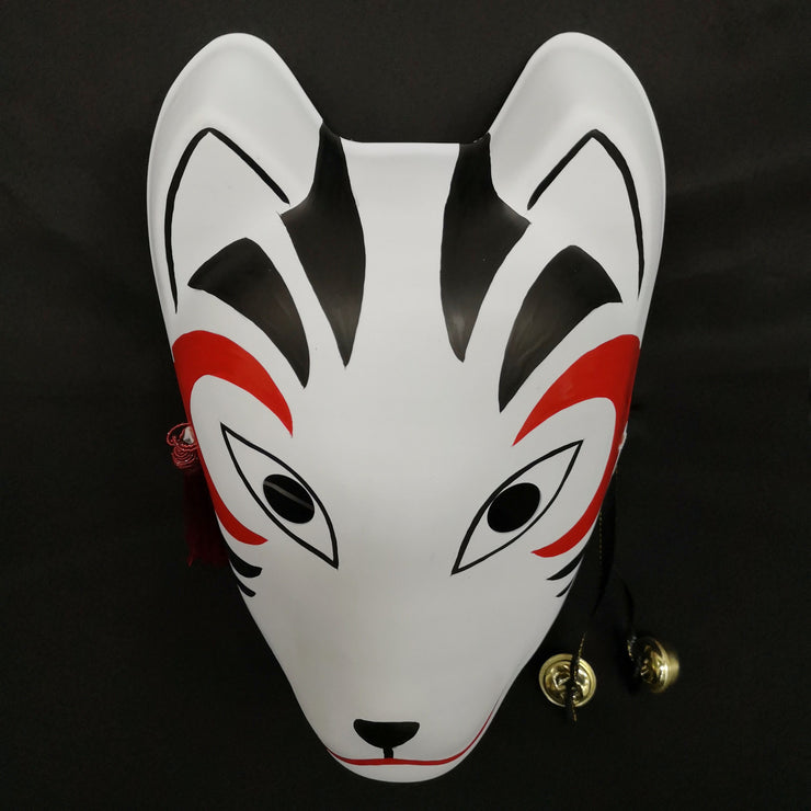 A hand-painted Kitsune (fox) mask with a strap, designed to resemble a cat's face with curved markings.