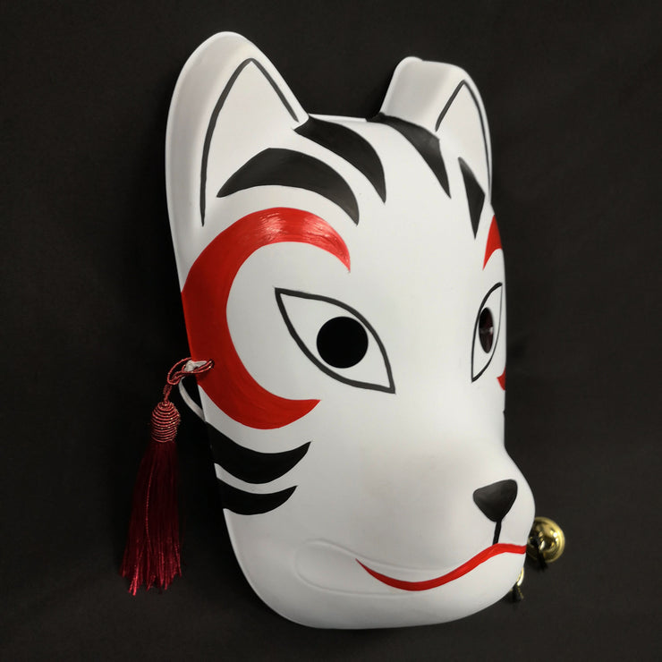 A hand-painted Kitsune (fox) mask with a strap, designed to resemble a cat's face with curved markings.
