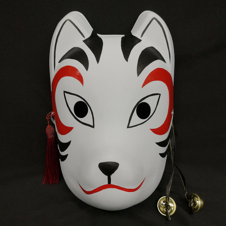 A hand-painted Kitsune (fox) mask with a strap, designed to resemble a cat's face with curved markings.