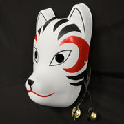 A hand-painted Kitsune (fox) mask with a strap, designed to resemble a cat's face with curved markings.