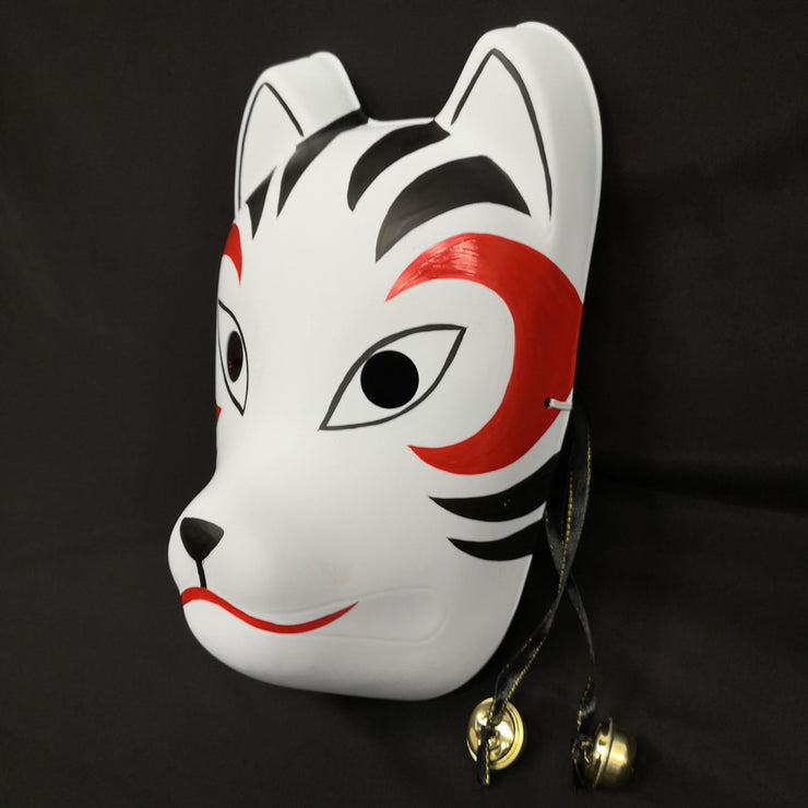 A hand-painted Kitsune (fox) mask with a strap, designed to resemble a cat's face with curved markings.