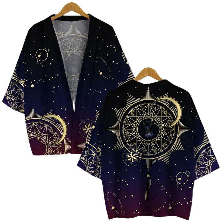 A unisex kimono cardigan with a geometric and celestial pattern, displayed on two wooden hangers.